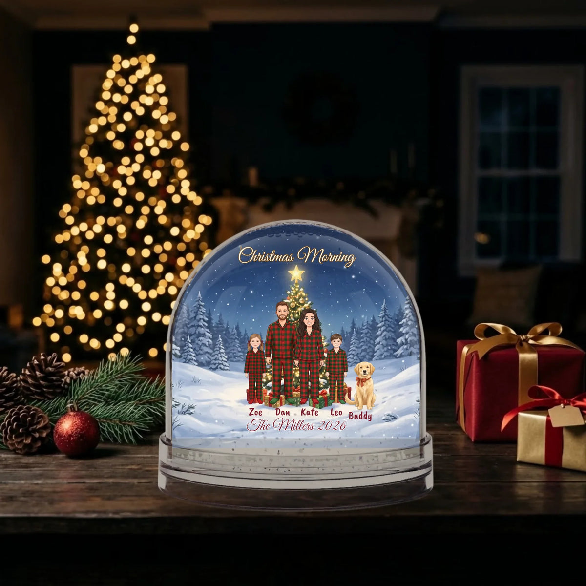 Family snow globe gift beside a glowing Christmas tree and presents at night