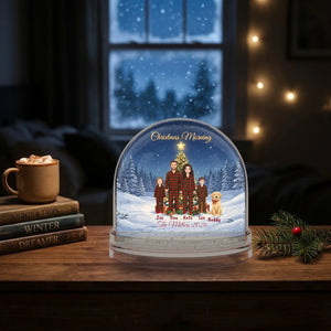 Personalized family snow globe keepsake on a bedroom nightstand at night